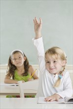 Young girl raising hand in class. Date : 2006