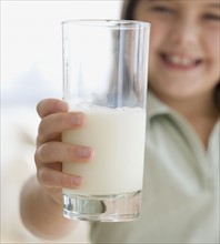 Girl holding glass of milk. Date : 2006