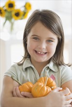 Portrait of girl holding pumpkins. Date : 2006