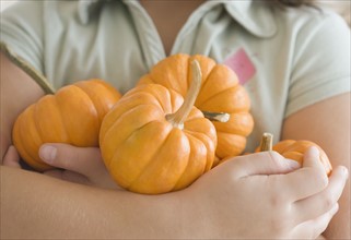 Close up of girl holding pumpkins. Date : 2006