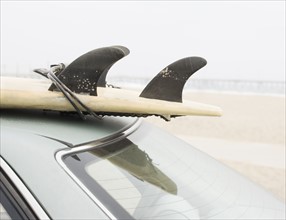 Close up of surfboard on top of car at beach. Date : 2006