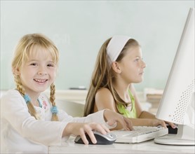 Two young girls using computers. Date : 2006