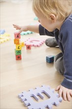 Toddler stacking blocks. Date : 2006