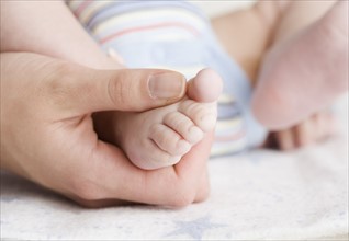 Close up of baby’s foot in mother’s hand. Date : 2006
