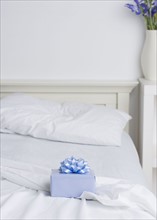 Still life of gift box on bed. Date : 2006