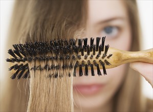 Close up of hairbrush in woman’s hair. Date : 2006