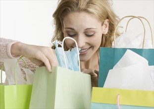 Woman looking in shopping bags. Date : 2006
