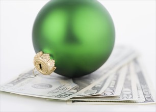 Studio shot of money and Christmas tree ornament. Date : 2006