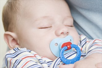 Close up of sleeping baby with pacifier. Date : 2006