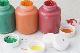 Closeup of paint bottles and lids. Date : 2006
