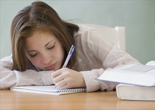 Woman writing in notebook. Date : 2007