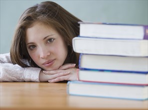 Woman next to stack of school books. Date : 2007