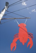 Lobster shaped sign under blue sky, Maine, United States. Date : 2007