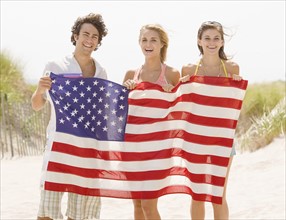 Friends holding American flag. Date : 2007