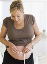 Pregnant woman measuring belly. Date : 2007