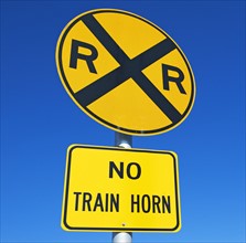 Low angle view of Railroad crossing sign. Date : 2007