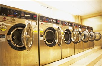 Row of washing machines in laundromat. Date : 2007