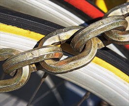 Close up of chain over bicycle tire. Date : 2007