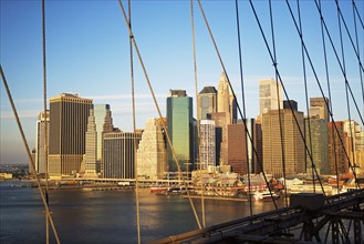 View of skyline through Brooklyn Bridge, New York City. Date : 2007