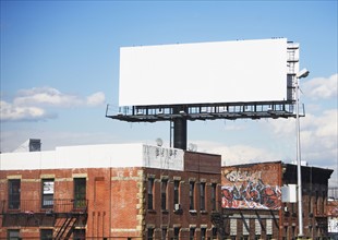 Blank billboard over urban buildings. Date : 2007