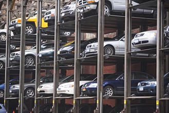 Cars stacked in urban parking lot. Date : 2007