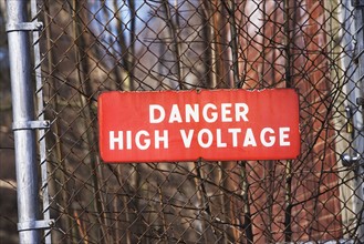 Danger High Voltage sign on fence. Date : 2007