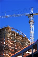Low angle view of construction site and crane. Date : 2007