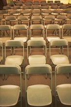 Empty folding chairs in rows. Date : 2007