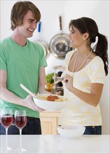 Couple preparing food in kitchen. Date : 2007