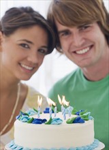 Couple behind birthday cake. Date : 2007