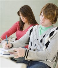 Male and female college students in classroom. Date : 2007
