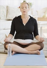 Pregnant woman meditating. Date : 2007