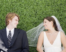 Bride and groom laying in grass. Date : 2007