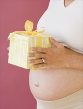 Pregnant woman holding gift. Date : 2007