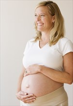 Pregnant woman with hands on belly. Date : 2007