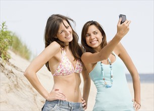 Young women taking own photograph. Date : 2007