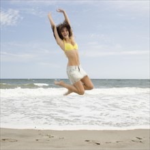 Woman jumping at beach. Date : 2007