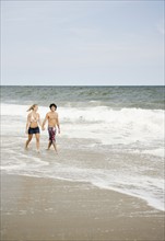 Couple walking in ocean surf. Date : 2007