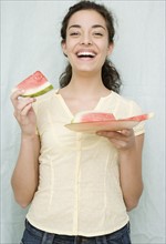 Woman eating watermelon slices. Date : 2007