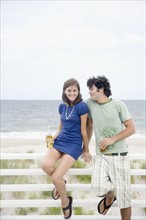Couple drinking beer at beach. Date : 2007