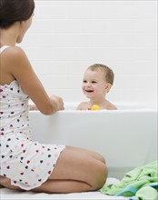 Mother giving baby a bath. Date : 2007