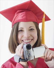 Female graduate holding video camera. Date : 2007