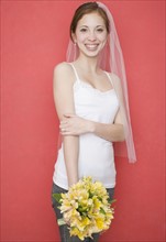 Woman wearing bridal veil and holding flowers. Date : 2007