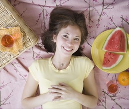 Woman laying on picnic blanket. Date : 2007
