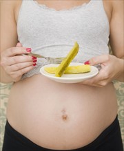 Pregnant woman eating pickles. Date : 2007