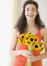 Woman holding bouquet of sunflowers. Date : 2007