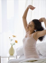 Woman stretching on bed. Date : 2007