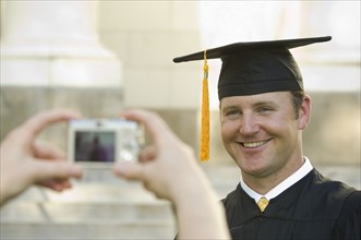 Male graduate having photograph taken. Date : 2007