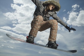 Low angle view of snowboarder jumping. Date : 2007