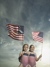 Two young sisters holding American flags. Date : 2007